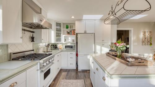 a kitchen with white cabinets and a white refrigerator at Luxury Wine Country Haven Vineyard Views Near Top Wineries Adelaida Farmhouse in Paso Robles