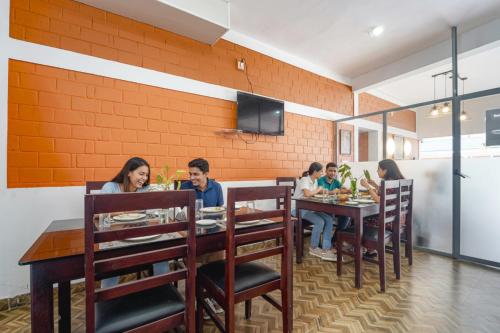 a group of people sitting at a table in a restaurant at Fabhotel Star Inn Plus - Nr Kovalam Beach in Kovalam
