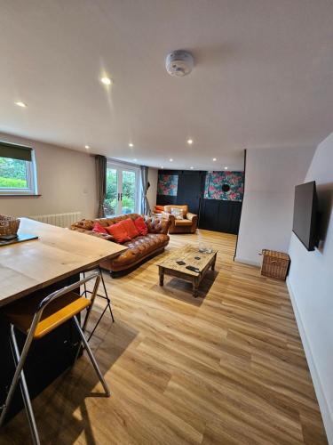 a living room with a couch and a table at Upper Winstone Pond Lodge in Isle of Wight