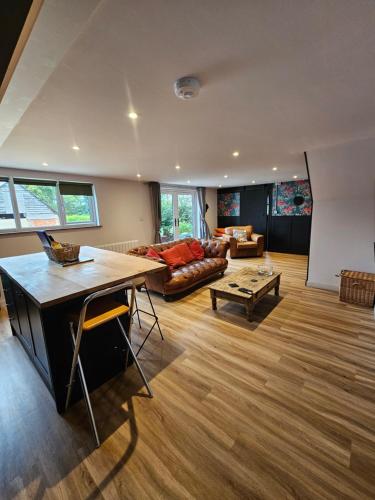 una sala de estar con un sofá y una mesa en Upper Winstone Pond Lodge, en Isle of Wight