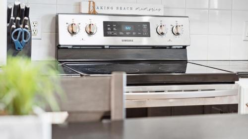 a kitchen with an oven in a kitchen at Oceanfront w Pool Panoramic Deck Views 5BDR Folly Ocean Breeze by AvantStay in Folly Beach