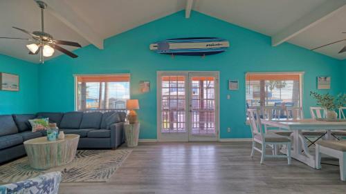 a living room with a couch and a table at Coastal Retreat w Pool BBQ Sunset Views Beers and Sunshine by AvantStay in Port Aransas