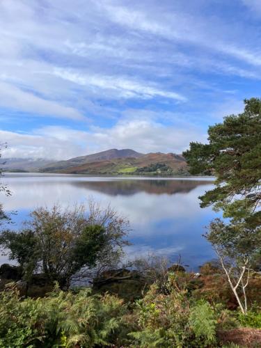 a view of a lake with mountains in the background at Caragh Lake House - Lakefront Escape and Sauna in Killorglin