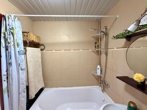 a bathroom with a tub and a sink at Apartment "Gluecks-Griff" inside "Becici Sunset Apartments" in Budva