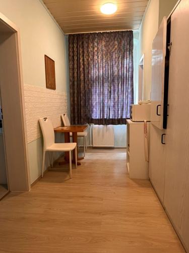 a small room with a table and a window at Hotel Elisenhof in Chemnitz