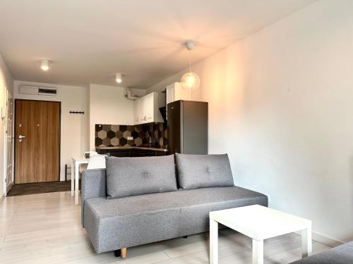 a living room with a couch and a kitchen at Przedmiejska Apartment - Self check-in 20h in Wrocław