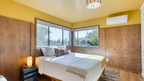 a bedroom with a large bed and a window at Walk to Beach Shops Fireplace Patio Dining Firepit at Manzanita Ave. in Manzanita
