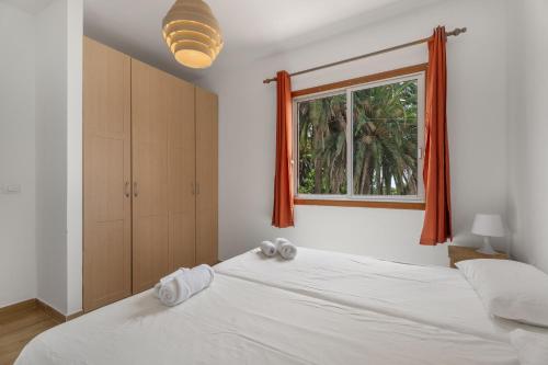 a bedroom with a large white bed and a window at Casa Palmar by Paramount Holidays in Valle Gran Rey
