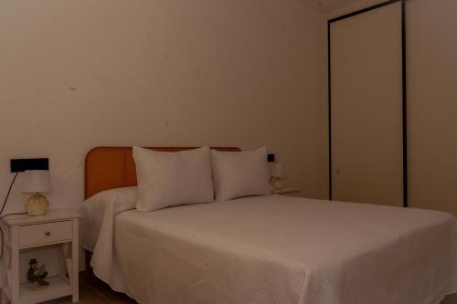 Ένα ή περισσότερα κρεβάτια σε δωμάτιο στο Oliva Suite Apartamentos