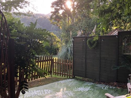 a wooden fence with a gate in a garden at The Nest Danehill in Haywards Heath