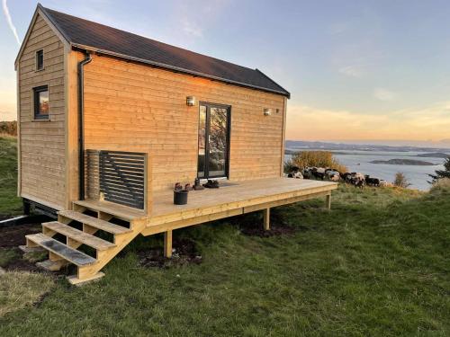 a tiny house on a hill with a deck at Gjeterhytta in Stavanger