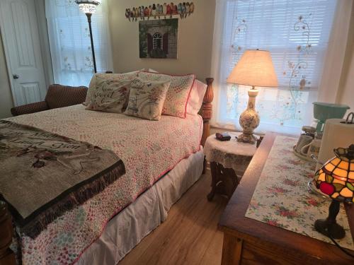 a bedroom with a bed with a lamp and a table at 2066 Hawkins Mill Road in Lynchburg
