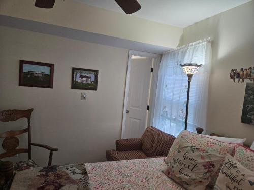 a bedroom with a bed and a chair and a window at 2066 Hawkins Mill Road in Lynchburg