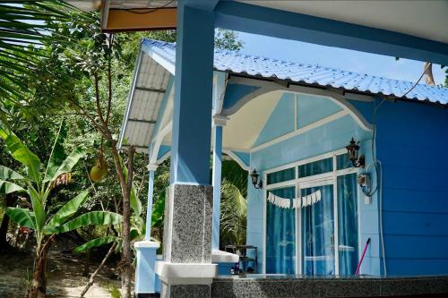 una casa azul con una puerta blanca en Garden Hostel Koh Rong, en Sihanoukville