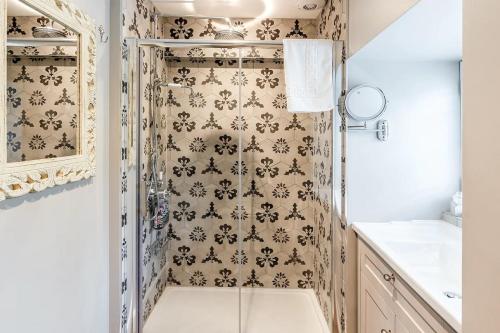 a bathroom with a shower with a shower curtain at The Buttery Tan House Newland in Newland