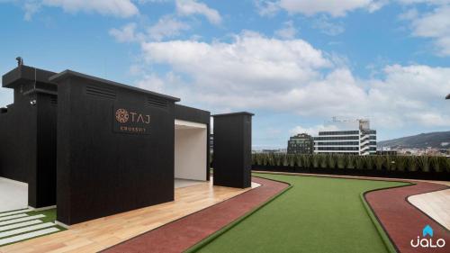 a rendering of a black building with a green lawn at Edificio Taj 97 By Jalo in Bogotá