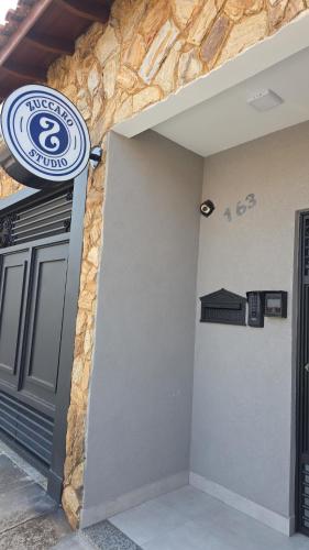 a building with a sign on the side of it at Zuccaro Studio 1 in Bauru