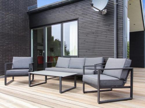 a patio with a couch and two chairs and a table at Holiday Home Rudolf - 3-5km from the sea by Interhome in Rømø Kirkeby