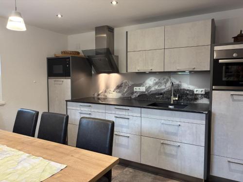 a kitchen with a table and a counter top at Holiday Home Machreich by Interhome in Bruck an der Großglocknerstraße
