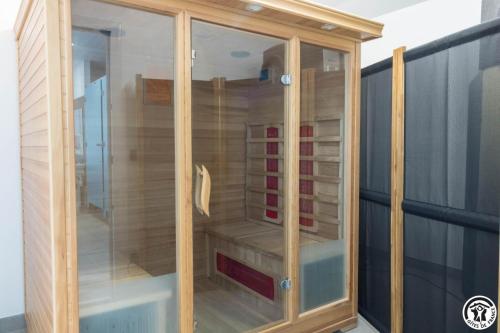a wooden cabinet with glass doors on a balcony at Chambres d'hôtes de montcausson in Revel