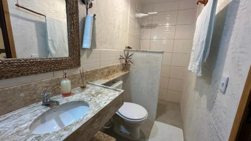 a bathroom with a sink and a toilet and a mirror at Sunshine Kite Inn in Prea