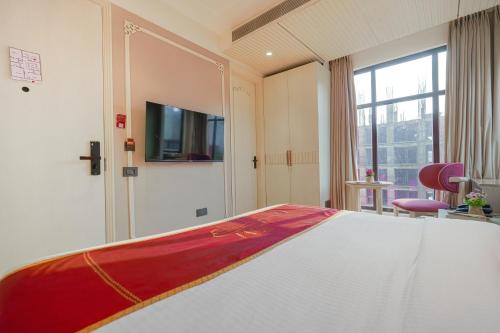 a hotel room with a bed and a tv at Hotel Red Martin 2 min walk from Golden Temple in Amritsar
