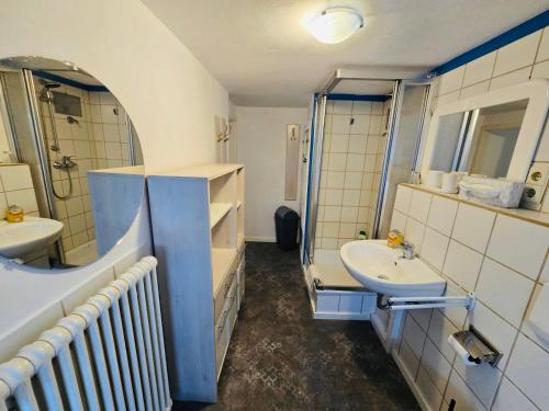 a bathroom with two sinks and a shower at Apartment Altstadt 50m vom Bodensee in Meersburg