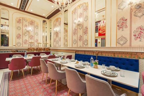 a restaurant with tables and chairs in a room at Hotel Red Martin 2 min walk from Golden Temple in Amritsar