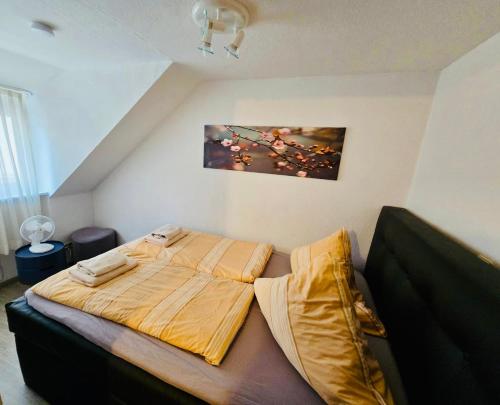 a large bed in a room with avertisement at Apartment Altstadt 50m vom Bodensee in Meersburg