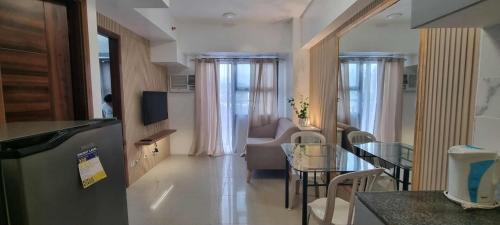 a kitchen and living room with a table and a couch at Evan's pad, Horizons 101 T1 in Cebu City