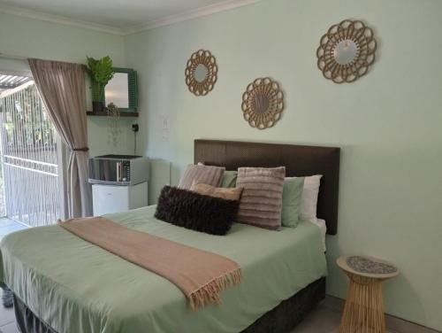 a bedroom with a large bed with pillows on it at Be Our Guest Near OR Tambo International Airport 2 in Boksburg