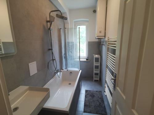 a bathroom with a tub and a sink at Apartmenthaus in Rüdersdorf in Rüdersdorf