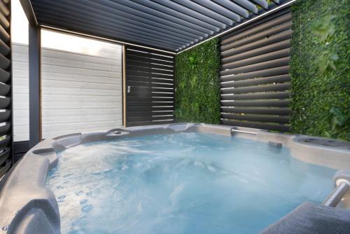 a jacuzzi tub in a room with plants at Silverdale Lodge, HotTub, Wi-FI, Quiet & Sleeps 4 in Warton