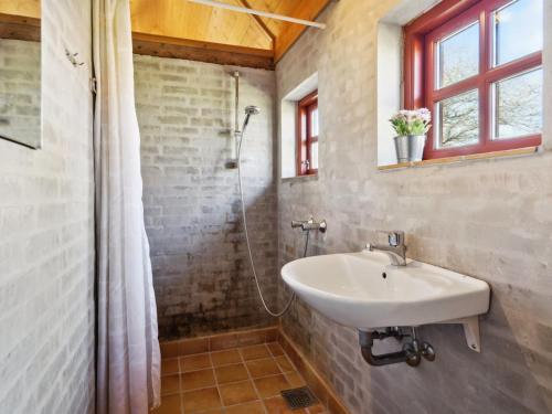 a bathroom with a sink and a shower at Holiday Home Henke - 100m from the sea by Interhome in Læsø