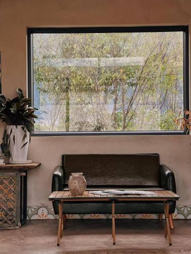 a bench sitting in front of a large window at DALI FLOWER&CAT VILLa in Dali
