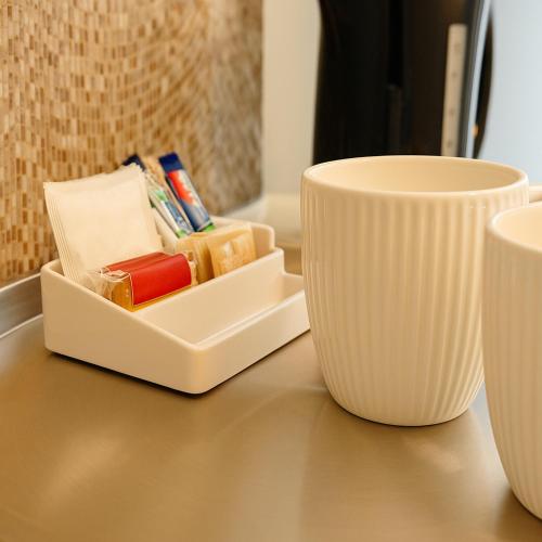 a table with two cups and a tray of soap at Shalom Stay London in London