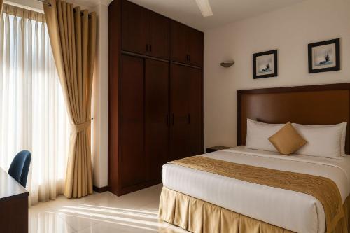 a hotel room with a bed and a window at Unique Towers Luxury Boutique Suites in Colombo
