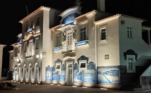 a large white building with blue and white tiles at Aveiro Train Studios in Aveiro