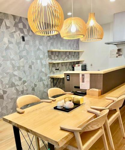 a dining room with a wooden table and chairs at ZenKyoto in Kyoto