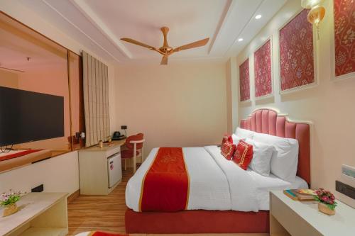 a bedroom with a bed with a red headboard at Hotel Red Martin 2 min walk from Golden Temple in Amritsar