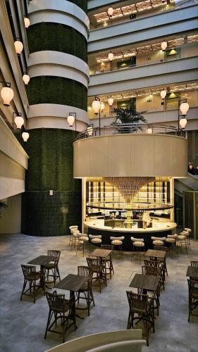 a large room with tables and chairs and a chandelier at Ribera de Triana Hotel in Seville