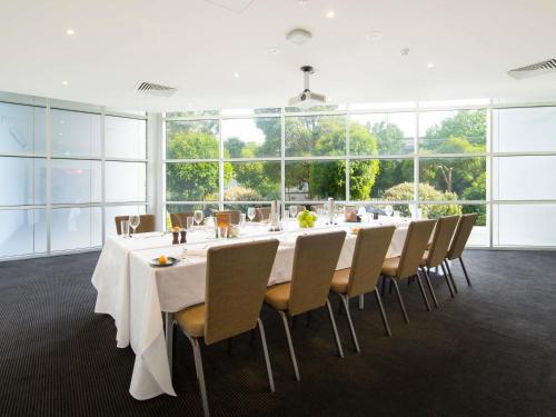 a large conference room with a long table and chairs at ibis Melbourne - Glen Waverley in Glen Waverley