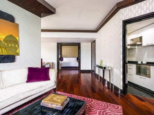 a living room with a couch and a table at Sofitel Mumbai BKC in Mumbai