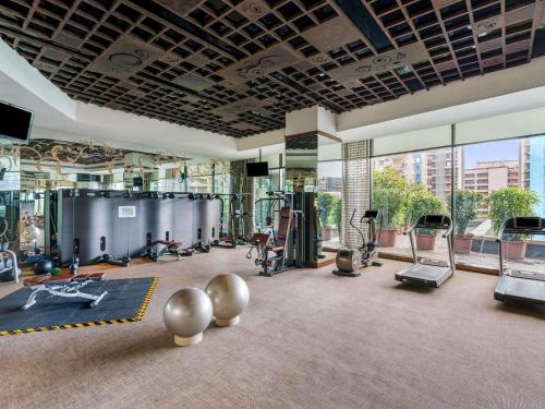 a gym with a lot of exercise equipment in a building at Sofitel Mumbai BKC in Mumbai
