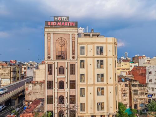 a building with a sign on top of it at Hotel Red Martin 2 min walk from Golden Temple in Amritsar