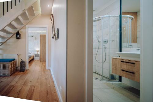 a bathroom with a sink and a glass shower at Dolina Wikingów 2-poziomowy apartament w Norweskiej Dolinie z dwoma balkonami i dostępem do strefy Wellness in Szklarska Poręba