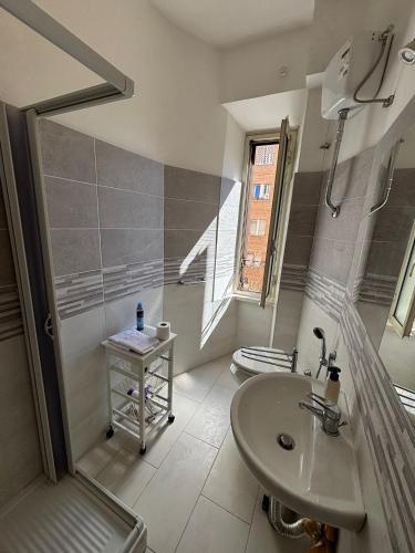 a white bathroom with a sink and a toilet at Testaccio Immobiliare in Rome