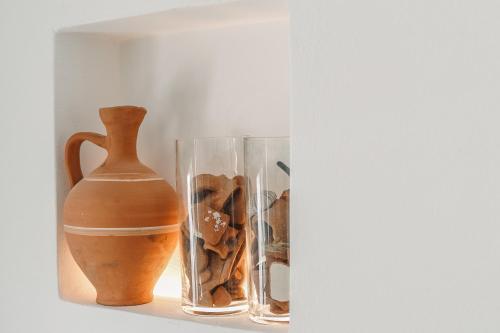 a shelf with two vases and a vase on it at Turquoise in Platis Yialos Sifnos