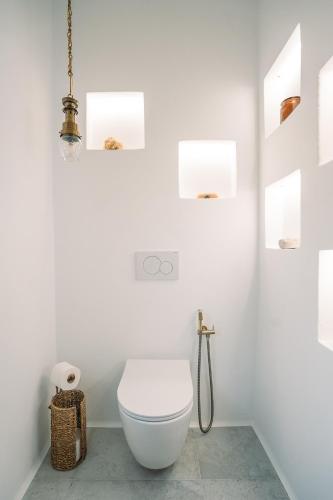 a white bathroom with a toilet in a room at Turquoise in Platis Yialos Sifnos