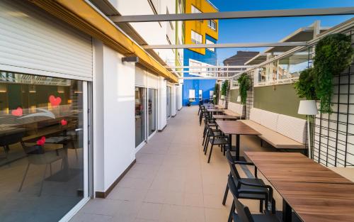 an empty corridor of a restaurant with tables and chairs at Vistamar Hotel Luxury Wellness By DLV -Adults Only- in Villajoyosa